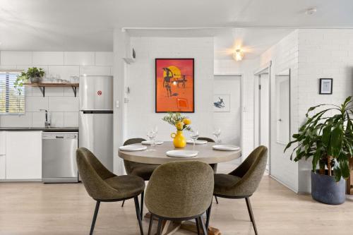 a kitchen and dining room with a table and chairs at Bayswell by Experience Jervis Bay in Huskisson