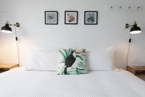 a bedroom with a bed with a pillow on it at Bayswell by Experience Jervis Bay in Huskisson