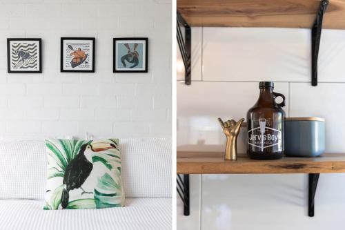 a room with a white wall and a table with a couch at Bayswell by Experience Jervis Bay in Huskisson