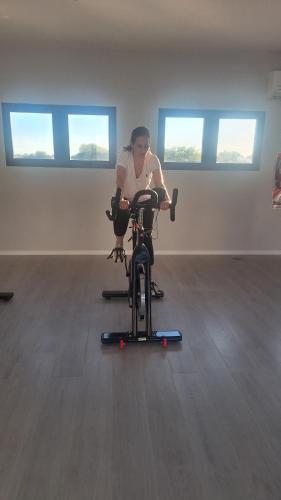 a woman sitting on a exercise bike in a room at Hotel Boutique Gualamba in General Pinedo