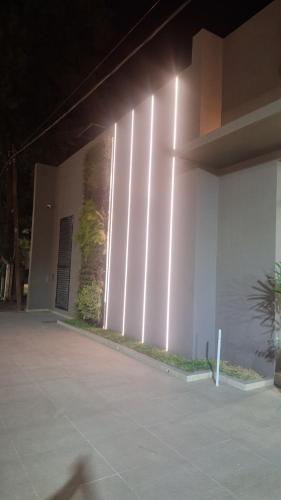 a building with lights on the side of it at Hotel Boutique Gualamba in General Pinedo