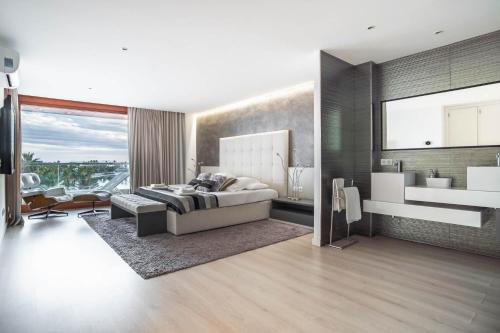 a bedroom with a bed and a sink in a room at Luxury sea view Apartment in Puerto de Alcudia in Alcudia