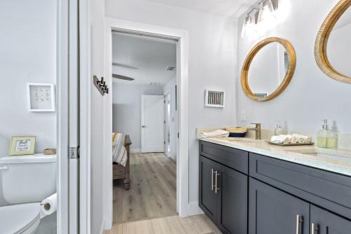 a bathroom with a sink and a mirror at Sunrise Hideaway - Ocean View Luxury Pool Home - 350 Feet to the Beach in New Smyrna Beach