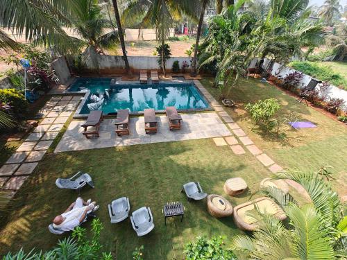 an overhead view of a swimming pool with chaise lounge chairs at SOLS Backyard in Arambol