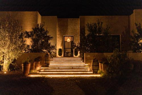 a building with stairs leading to a door at night at Atlas Retreat Luxury Bed and Breakfast in Beni Mellal