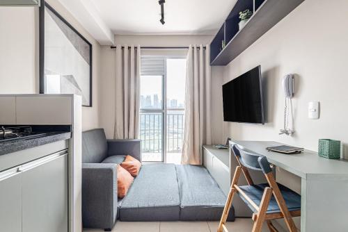 a small apartment with a kitchen and a desk with a couch at Laguna 1809 - Seu espaço em SP in Sao Paulo
