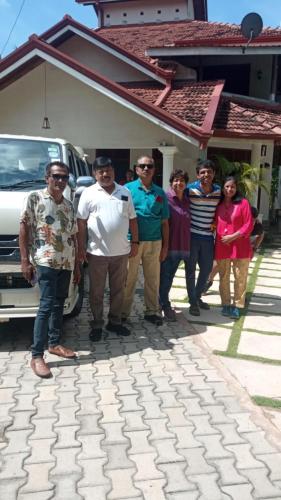 a group of people standing in front of a house at Marigold Negombo in Negombo