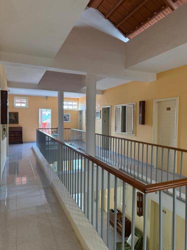 a large hallway with a staircase in a building at Pousada Praia Maria in Praia