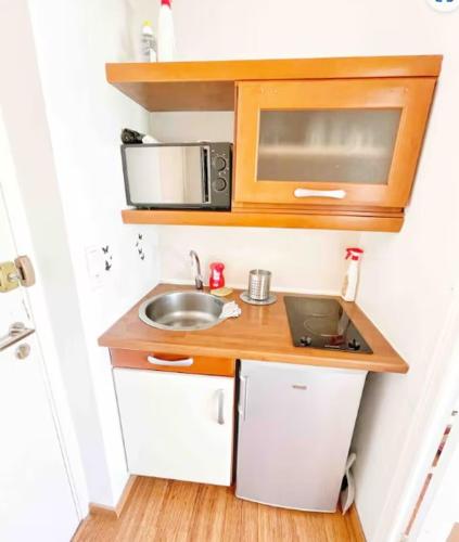 une petite cuisine avec un évier et un micro-ondes dans l'établissement #A1K STUDIO JUNIOR - MARINA RIVIERA BAY Near Airport, à Villeneuve-Loubet
