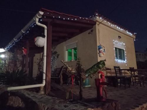 a house with christmas lights on it at night at zikos house in Monemvasia
