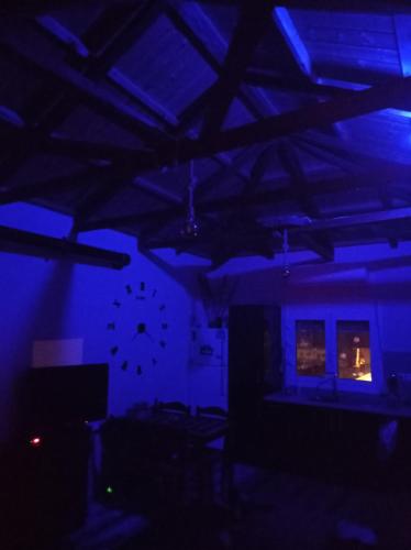 a dark room with blue lighting and a clock on the wall at zikos house in Monemvasia