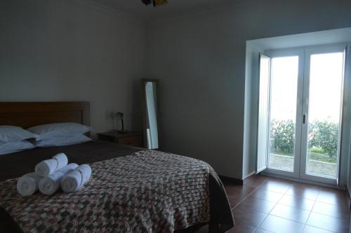a bedroom with a bed with white towels on it at Casa nos Penedos in Arcos de Valdevez