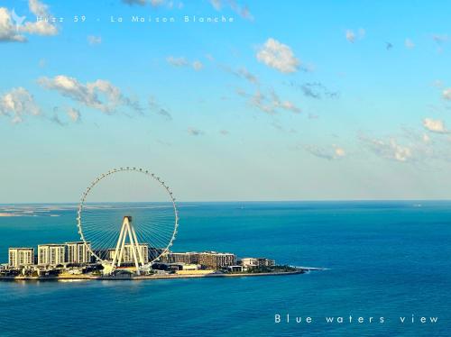a large ferris wheel in the middle of the ocean at Huzz 59 - La Maison Blanche in Dubai