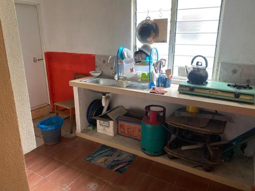 a kitchen with a sink and a counter top at Banglo Semi D Villa D Doa Maju in Kuala Terengganu