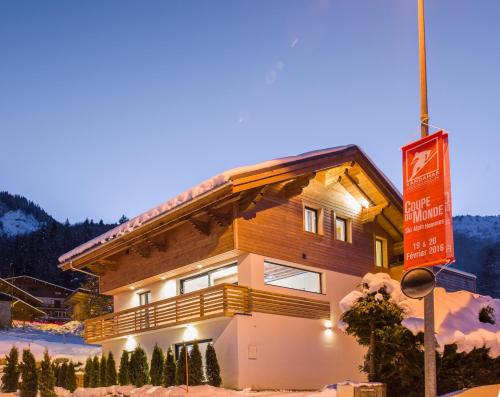a building with a sign in the snow at Chalet Rubicon in Les Houches