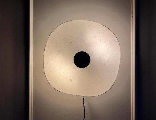 a white object with a hole in it on a wall at Wiltsangh Texel Tuinsuite Black in De Waal