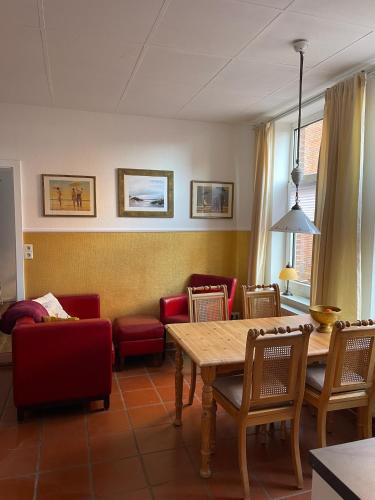 a living room with a table and chairs at Aparthotel Domizil in Borkum