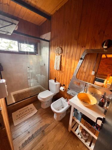 a bathroom with a toilet and a shower and a sink at Aerohouse in Posadas