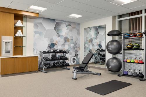 a fitness room with a gym with a chair and weights at SpringHill Suites by Marriott Easton PA in Easton