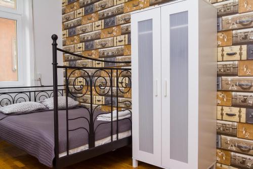 a bedroom with a bed and a wall of wine bottles at Retro Hostel in Poznań