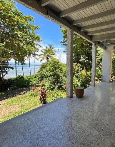 an outdoor porch with a view of the beach at Casa Susen in Montezuma