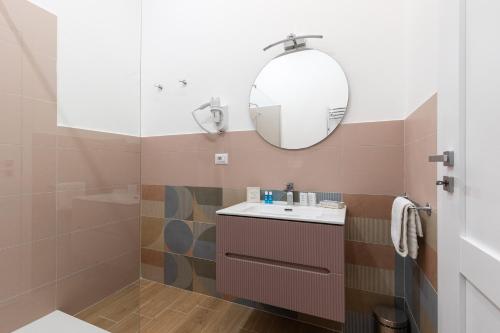 a bathroom with a sink and a mirror at B&B Vitruvio Suites in Formia