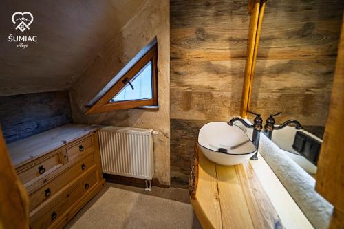 a bathroom with a sink and a window at Šumiac Village - Jedinečné ubytovanie s wellnessom pod Kráľovou hoľou in Šumiac