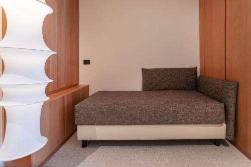 a small bedroom with a bed in a room at LLAC Living Nature Hotel in Limone sul Garda