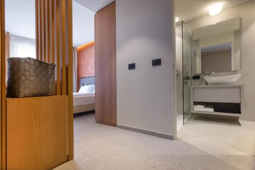 a bathroom with a sink and a mirror at LLAC Living Nature Hotel in Limone sul Garda