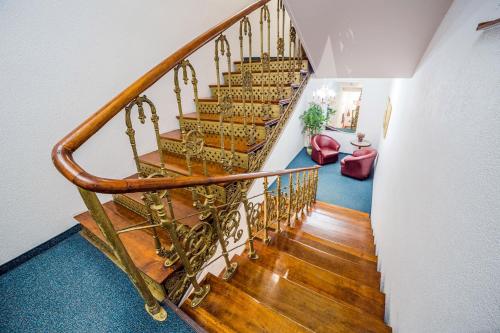 a staircase in a home with a wooden railing at Hotel TM in Radom