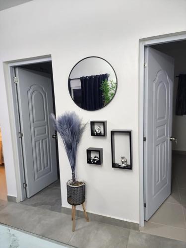 a hallway with two doors and a mirror at Villa Victoria in Sosúa