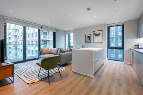 a living room with a couch and a table at Alto Apartment - Modern Comfort & Prime Location in London