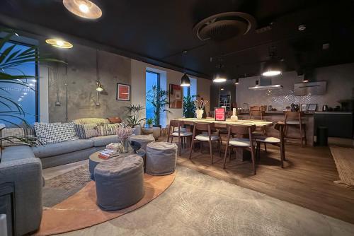 a living room with a couch and a table and chairs at Alto Apartment - Modern Comfort & Prime Location in London