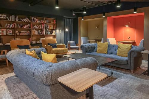 a living room with two couches and a table at Alto Apartment - Modern Comfort & Prime Location in London