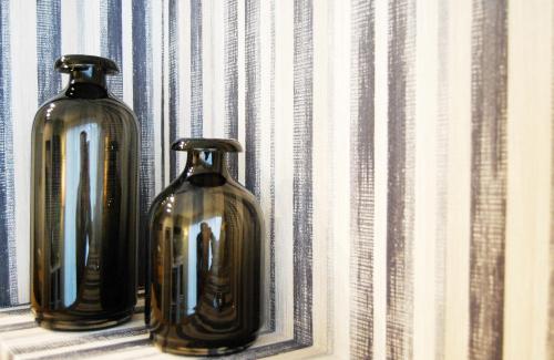 two vases are sitting on a window sill at Serendipity Rooms in Milan