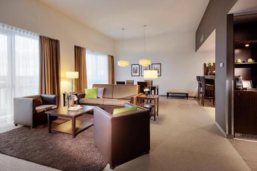 a living room with a couch and a table at Lindner Hotel Antwerp, part of JdV by Hyatt in Antwerp