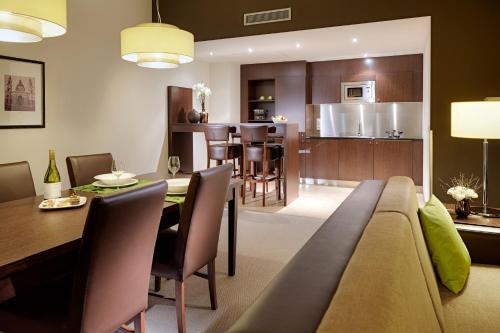 a living room and kitchen with a couch and a table at Lindner Hotel Antwerp, part of JdV by Hyatt in Antwerp
