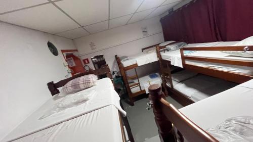 a room with three bunk beds in a hospital at COACHHOSTEL7 in Sao Paulo