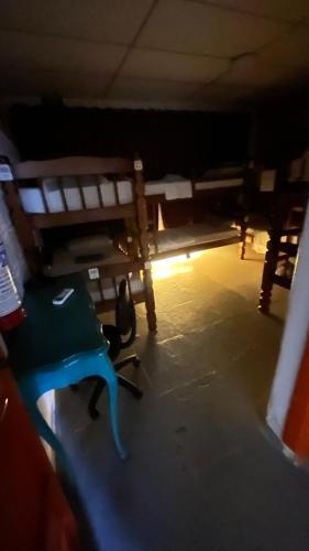 a room with two benches and a blue chair at COACHHOSTEL7 in Sao Paulo