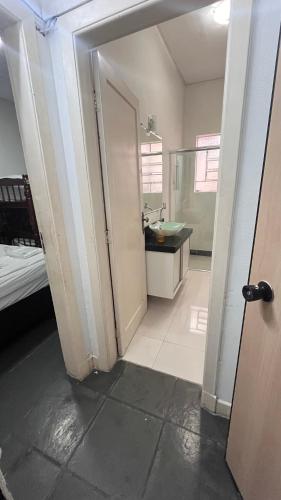an open door to a bathroom with a sink at COACHHOSTEL7 in Sao Paulo