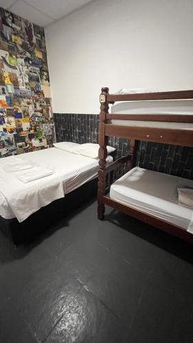 two bunk beds in a room with a wall at COACHHOSTEL7 in Sao Paulo