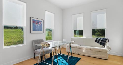 a living room with a couch and a glass table at Tranquil Lakefront Villa - Perfect for Weekdays or Weekends in South Jonestown Hills