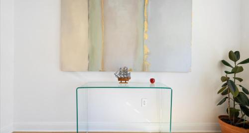 a glass cabinet in a room with a plant at Tranquil Lakefront Villa - Perfect for Weekdays or Weekends in South Jonestown Hills