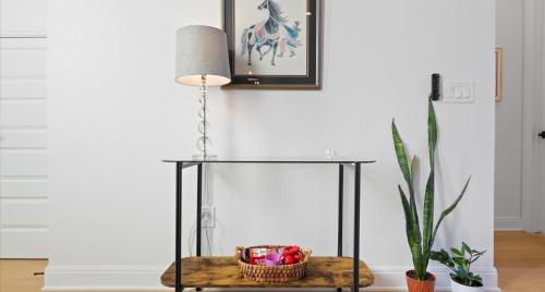 a glass table with a basket of toys and a plant at Tranquil Lakefront Villa - Perfect for Weekdays or Weekends in South Jonestown Hills