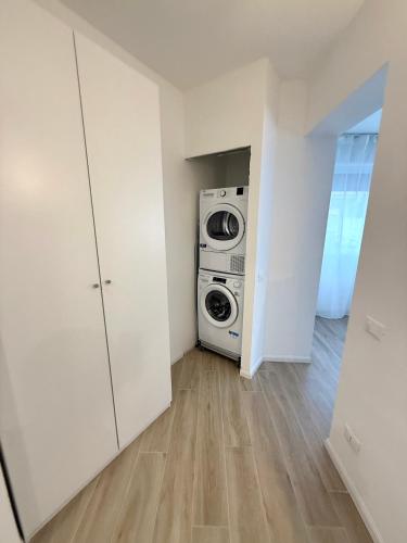 a laundry room with a washer and dryer in it at NOAcH experience in Livorno