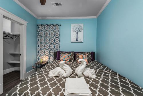 two stuffed animals sitting on a bed in a bedroom at Spacious 1-BR Midtown Houston Apt with King Bed & Free Parking in Houston