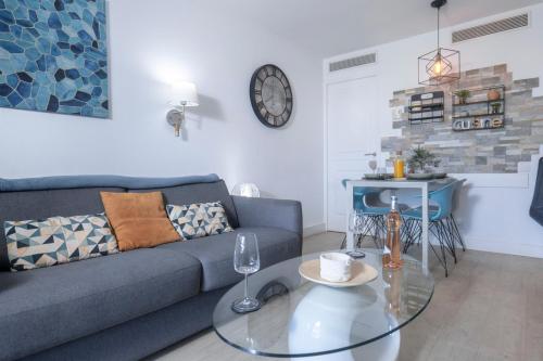 un salon avec un canapé et une table en verre dans l'établissement Le Panorama - Cannes Beach, à Cannes