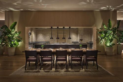 a dining room with a table and chairs at The Jeddah EDITION in Jeddah