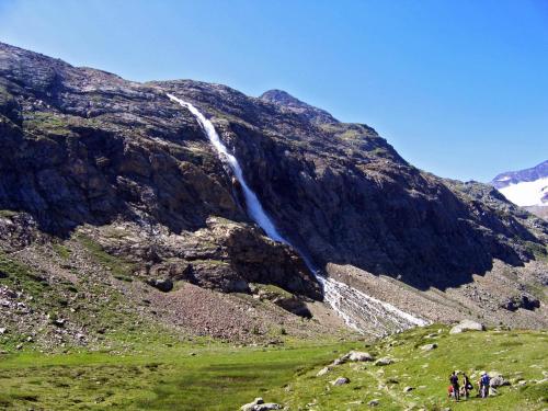 a waterfall on the side of a mountain at Ferienwohnungen Auhaus in Martello