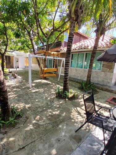 a patio with a chair and a house at Sharick Beach House in Tubará